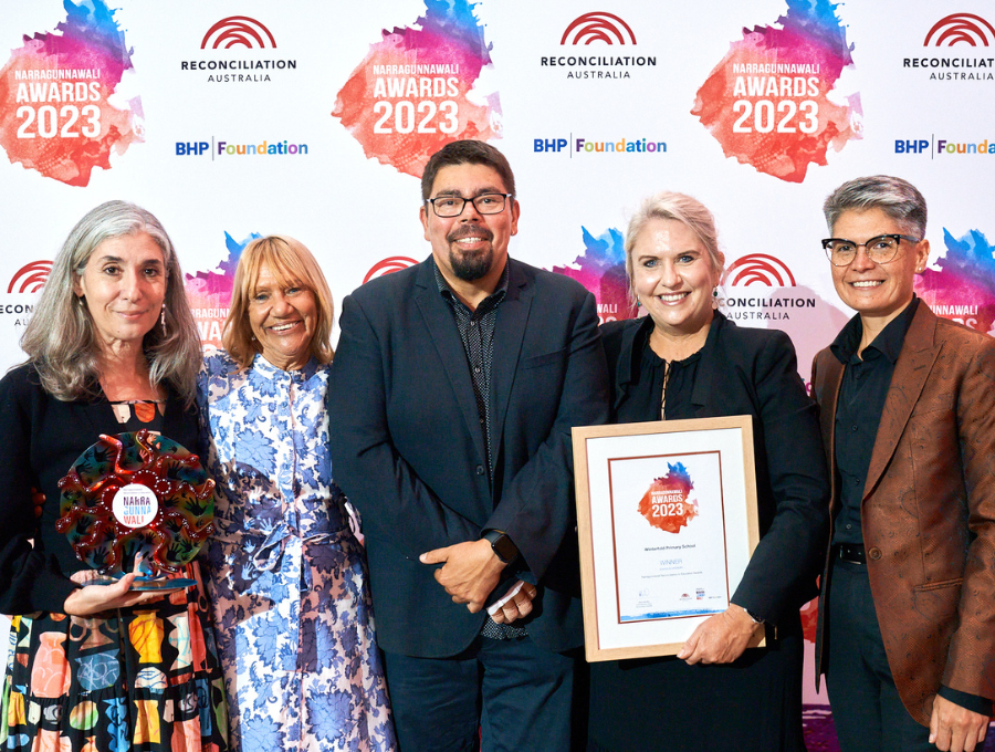 A group of five people - the three judges of the 2023 Narragunnawali Awards and two representatives from one of the winning schools, Winterfold Primary.